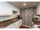 Bright kitchen with white cabinets, updated countertops, and a stone-look backsplash adding visual interest to the space at 2766 Del Prado Dr # 6, Indianapolis, IN 46227