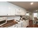Bright kitchen featuring white cabinets, subway tile backsplash, and wood countertops at 2766 Del Prado Dr # 6, Indianapolis, IN 46227