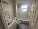 A full bathroom with a tub and shower combination, single sink, and toilet at 2826 Station St, Indianapolis, IN 46218