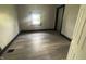 A bedroom showcases new floors and freshly painted walls and trim at 2826 Station St, Indianapolis, IN 46218