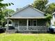 Two story home with a covered front porch and a lawn at 2826 Station St, Indianapolis, IN 46218