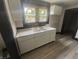 Newly renovated kitchen with stainless steel sink, marble countertops, and freshly painted cabinets at 2826 Station St, Indianapolis, IN 46218