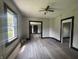 An open living room features new floors, fresh paint, and a ceiling fan at 2826 Station St, Indianapolis, IN 46218