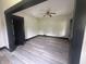 An open living room features new floors, fresh paint, and a ceiling fan at 2826 Station St, Indianapolis, IN 46218