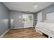 Cozy bedroom featuring a neutral color scheme, a large window, and light hardwood floors at 293 E Quail Wood Ln, Westfield, IN 46074