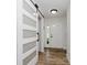 Bright entryway with modern sliding barn door, light wood floors, and a white front door at 293 E Quail Wood Ln, Westfield, IN 46074