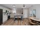 Eat-in kitchen with white cabinets, center island, wood floors, and access to the backyard at 293 E Quail Wood Ln, Westfield, IN 46074