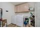 Functional laundry room with washer, dryer, and ample storage space at 293 E Quail Wood Ln, Westfield, IN 46074