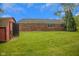 View of the backyard and exterior of the home with a shed at 3148 Arbutus Dr, Indianapolis, IN 46224