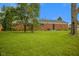 Backyard of brick home with spacious yard and mature trees at 3148 Arbutus Dr, Indianapolis, IN 46224
