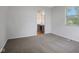 Bedroom with gray carpet, gray paint, and a window with an ensuite bath at 3148 Arbutus Dr, Indianapolis, IN 46224