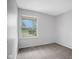 Bedroom with gray carpet, gray paint, and a window with outside view at 3148 Arbutus Dr, Indianapolis, IN 46224