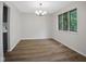 Open dining room with modern chandelier and view of backyard at 3148 Arbutus Dr, Indianapolis, IN 46224