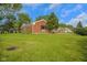 Charming single-story brick home with mature trees in a well-manicured lawn at 3148 Arbutus Dr, Indianapolis, IN 46224
