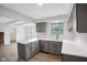 Modern kitchen boasts gray cabinets, stainless steel appliances, and pristine white countertops at 3148 Arbutus Dr, Indianapolis, IN 46224