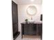 Stylish bathroom featuring black tiled floors, white subway tiled walls, and a gold framed mirror at 321 N Rangeline Rd, Carmel, IN 46032