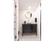 Stylish bathroom featuring black tiled floors, white subway tiled walls, and a gold framed mirror at 321 N Rangeline Rd, Carmel, IN 46032