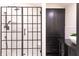 Modern bathroom featuring a glass-enclosed shower, white subway tile and black accents at 321 N Rangeline Rd, Carmel, IN 46032
