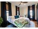 Bright bedroom with large windows, ceiling fan, and black out curtains over a plush queen bed at 321 N Rangeline Rd, Carmel, IN 46032