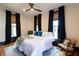 Comfortable bedroom featuring large windows, hardwood floors and a cozy rocking chair at 321 N Rangeline Rd, Carmel, IN 46032