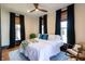 Comfortable bedroom featuring large windows, hardwood floors and a cozy rocking chair at 321 N Rangeline Rd, Carmel, IN 46032
