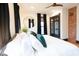 Bright bedroom featuring modern decor, including a round mirror and a wooden ceiling fan at 321 N Rangeline Rd, Carmel, IN 46032