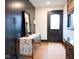 Charming entryway with a decorative wooden table, black accent wall, and light hardwood floors at 321 N Rangeline Rd, Carmel, IN 46032