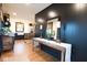 This entryway shows off its black accent wall, rustic console table, and entryway into the dining room at 321 N Rangeline Rd, Carmel, IN 46032