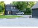 Two-story home with dark siding, well-kept lawn, and a modern vehicle in the driveway at 321 N Rangeline Rd, Carmel, IN 46032