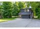 Two-story house with dark siding, and a driveway surrounded by mature trees at 321 N Rangeline Rd, Carmel, IN 46032