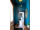 Entryway with blue walls, decorative mirror, and a view into the bedroom at 321 N Rangeline Rd, Carmel, IN 46032