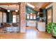 Modern kitchen featuring green backsplash, a skylight, a brick pillar, an island, and stainless steel appliances at 321 N Rangeline Rd, Carmel, IN 46032