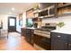 Modern kitchen with stainless steel appliances, quartz counters, and an adjacent dining area with hardwood floors at 321 N Rangeline Rd, Carmel, IN 46032