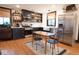 The kitchen features stainless steel appliances, black cabinets, and an adjacent dining area with hardwood floors at 321 N Rangeline Rd, Carmel, IN 46032
