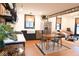 Bright, open kitchen boasts black cabinets, a stainless steel refrigerator, and an adjacent dining area at 321 N Rangeline Rd, Carmel, IN 46032