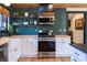 Beautiful kitchen with butcher block countertops, stainless steel appliances, green subway tile backsplash, and white cabinetry at 321 N Rangeline Rd, Carmel, IN 46032