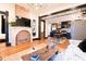 Cozy living room featuring an ornate fireplace, hardwood floors, and an open layout into the kitchen at 321 N Rangeline Rd, Carmel, IN 46032