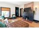 Cozy living room with a brick fireplace, comfortable seating, and stylish decor at 321 N Rangeline Rd, Carmel, IN 46032