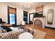 Comfortable living room with a decorative fireplace, large windows, hardwood floors and an elegant light fixture at 321 N Rangeline Rd, Carmel, IN 46032