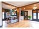Spacious open-concept living area featuring exposed wood beams, hardwood floors, and modern decor at 321 N Rangeline Rd, Carmel, IN 46032