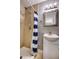 Bathroom featuring a toilet, sink with vanity, blue accent wall, and a shower with blue and white curtain at 321 S Biltmore Ave, Indianapolis, IN 46241