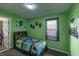 Bright bedroom with Minecraft-themed bedding, large window, and green walls for a playful atmosphere at 321 S Biltmore Ave, Indianapolis, IN 46241