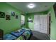 This bedroom features vibrant green walls, playful decor, and a cozy bed, creating a fun space at 321 S Biltmore Ave, Indianapolis, IN 46241
