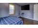 This bedroom features a desk, large window and TV; ideal for work or relaxation at 321 S Biltmore Ave, Indianapolis, IN 46241