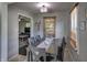 Traditional dining room with a light fixture, neutral walls, wood table, and wood blinds on the window at 321 S Biltmore Ave, Indianapolis, IN 46241