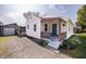 Home showcasing a welcoming front porch and gravel driveway at 321 S Biltmore Ave, Indianapolis, IN 46241