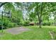 Spacious backyard featuring a basketball court, storage shed, and ample green space, perfect for outdoor activities at 3425 Ireland Dr, Indianapolis, IN 46235