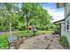 Cozy backyard patio with a bench, grill, and statue, ideal for outdoor relaxation and entertaining at 3425 Ireland Dr, Indianapolis, IN 46235