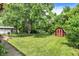 Lush backyard with mature trees, shed, and ample green space at 3425 Ireland Dr, Indianapolis, IN 46235