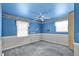 Blue bedroom featuring a ceiling fan and wainscoting at 3425 Ireland Dr, Indianapolis, IN 46235